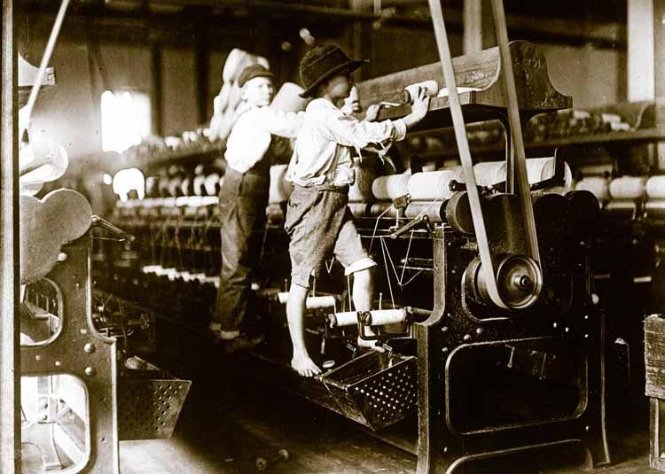 P L A C A R D L Industrial Revolution Children work at a textile mill in the state of Georgia around 1909.