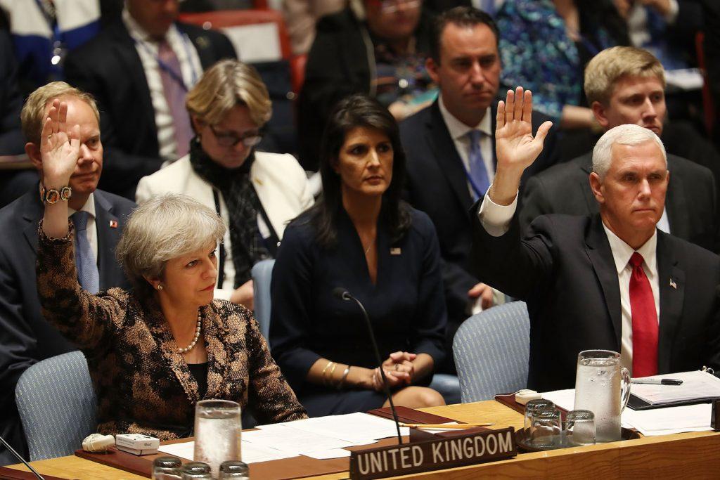 U.S. Vice President Mike Pence (R) and British Prime Minister Theresa May vote on a resolution during a Security Council meeting at the 72nd U.N. General Assembly at U.N. headquarters on Sept.