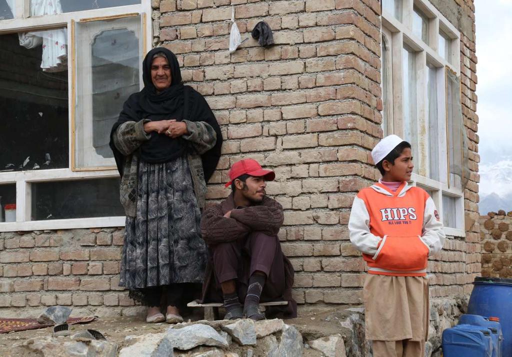 Marjan and two of her three sons in front of their family s home in Kabul. Her husband died when her oldest son was just a baby.