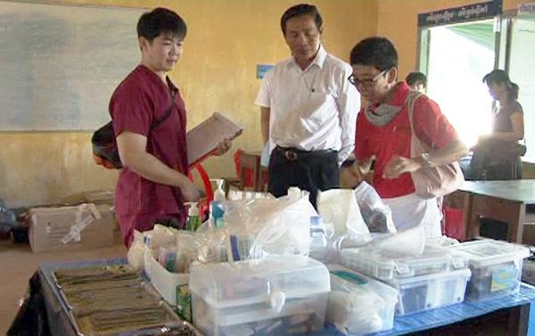 accompanied by okhna Sieng Nam, a lawmaker in Siem Reap province, provides free dental