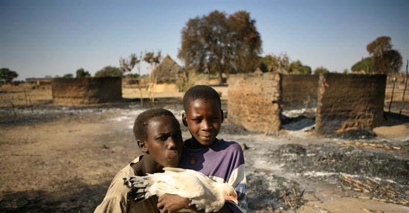 Chadian boys in front of their destroyed homes in Aradif village, which was attacked in December 2006. UNHCR/ H.