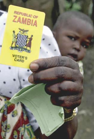 A Zambian shows her voting card during the Presidential elections held in December 2001.