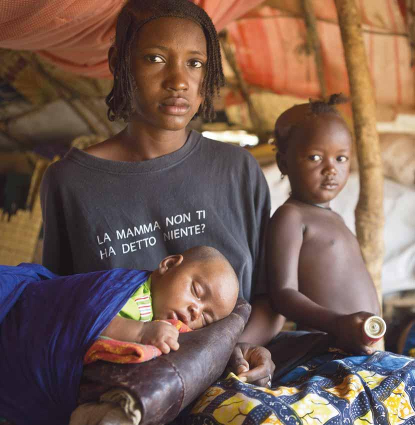 Teenager Aminata with her two-monthold daughter, Aichatou, and other young relatives in Burkina Faso s Damba Refugee Camp