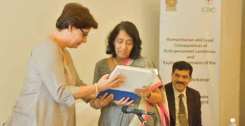 WHAT WAR LEAVES BEHIND Head of Delegation, ICRC Colombo, Claire Meytraud, presents Secretary, Ministry of Foreign Affairs, Chithranganee Wagiswara, the ICRC s manual on Weapon Contamination.