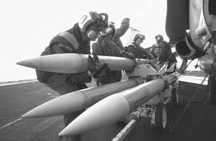 190 OPERATION ENDURING FREEDOM Members of VFA-37 s Ordnance Control manually load an AIM-120 AMRAAM Missile onto an FA-18 Hornet on the flight deck of the USS Harry S. Truman on March 1, 2003.