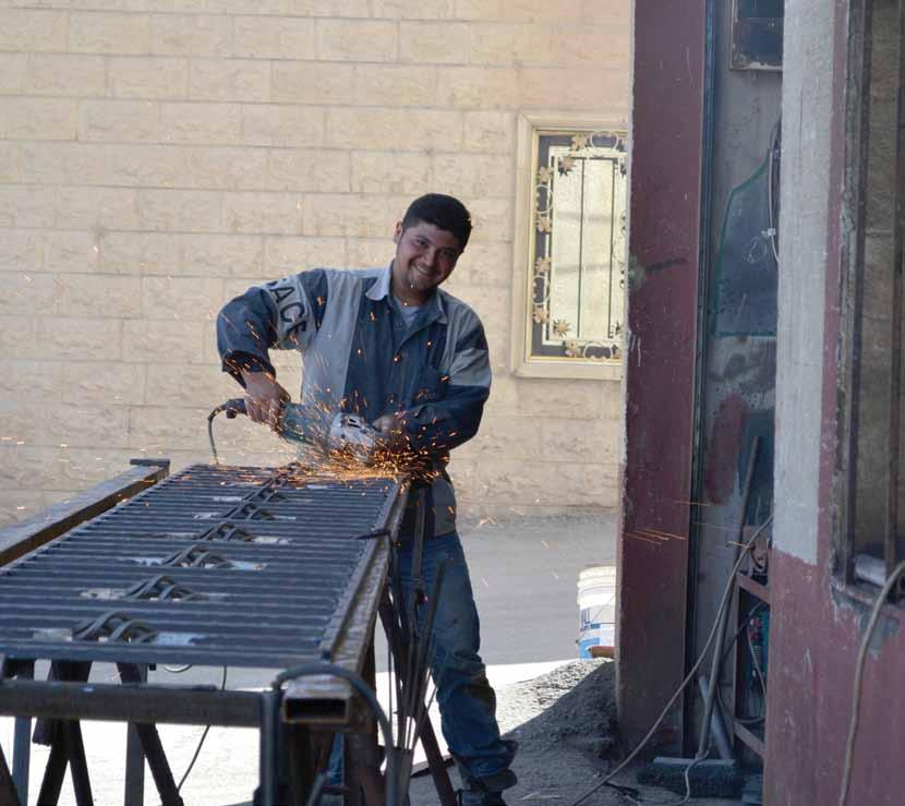 A Lebanese returnee uses the masonry tools provided by an IOM in-kind grant in the Bekaa.