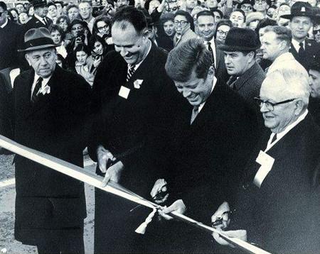 President Kennedy cuts a ribbon on a