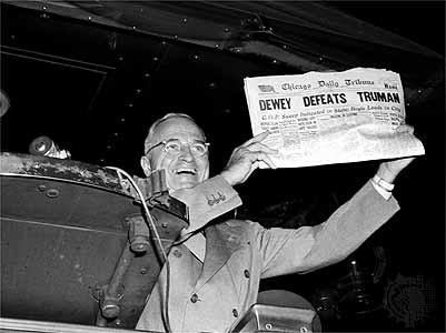 President Truman holds up paper