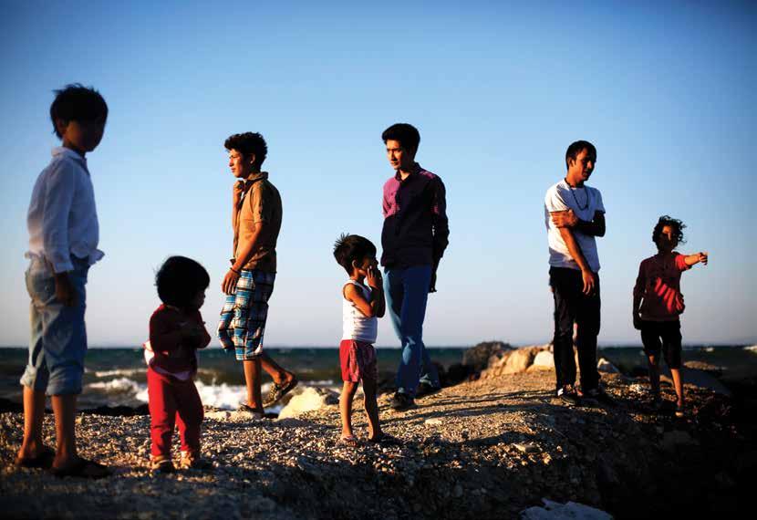 Durable Solutions and New Displacement An extended family of Afghan asylum-seekers, newly arrived on Greece s Lesvos Island, wait on the beach for the police to register them.