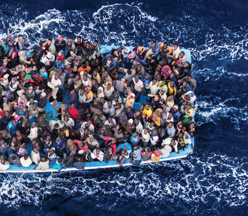 Hundreds of refugees and migrants crowded on a fishing boat are pictured moments before being rescued by the Italian Navy under its former Mare Nostrum operation in June 2014.