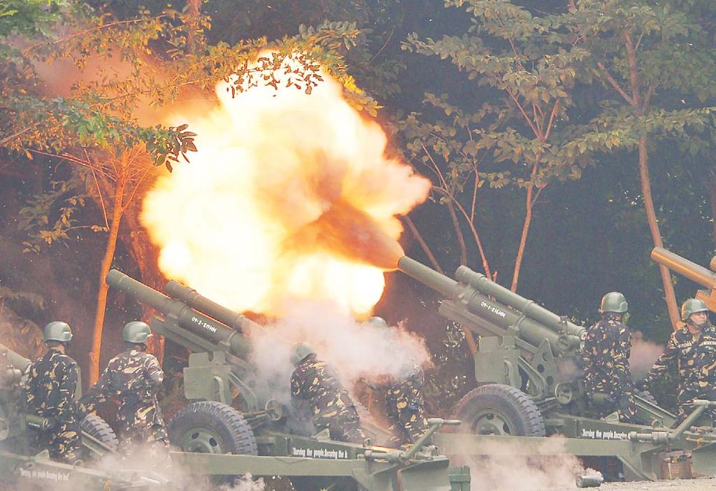 INTERNATIONAL 11 North Korea Philippine army artillery personnel fire 105 howitzer cannons during the turn-over ceremony of the army commanding general at Fort Bonifacio in Manila on Oct 5.