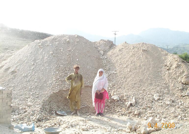 Asbestos in Pakistan Workers standing beside an asbestos dump at