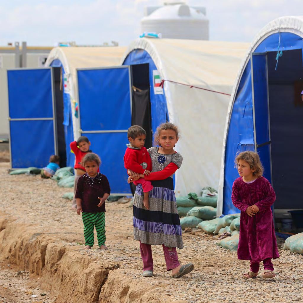 Displaced Iraqi children from Mosul by their tents