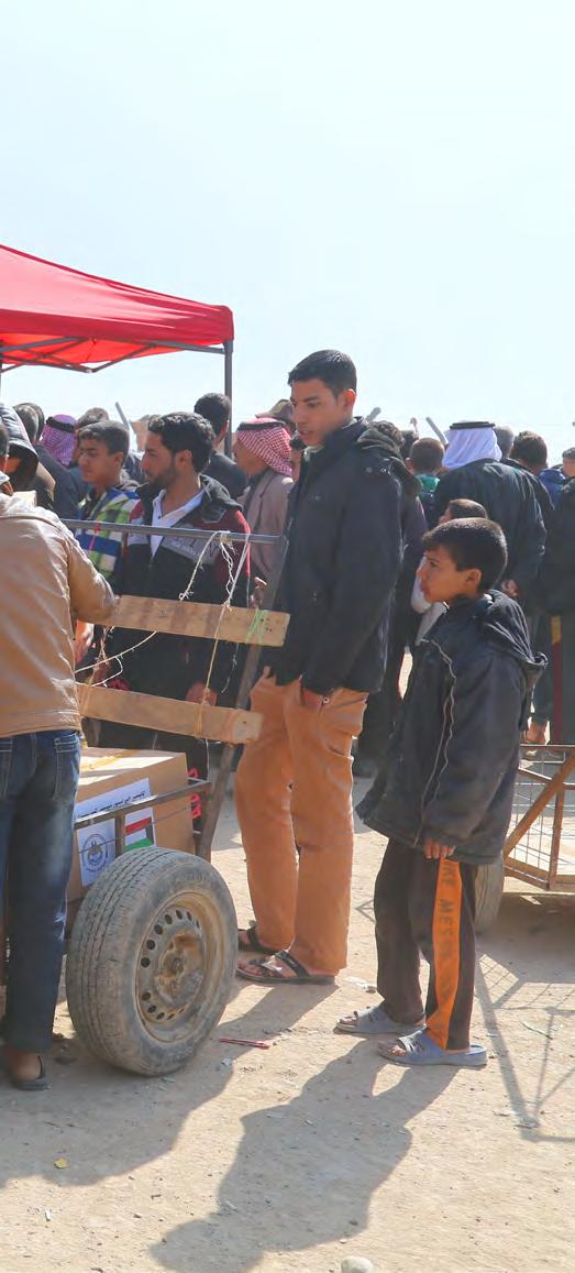 Displaced Iraqis receive winter clothes at a clothing distribution in Qayara Emergency Site, Ninewa governorate More than 10,000 adults benefitted from clothing distributions funded by the Government
