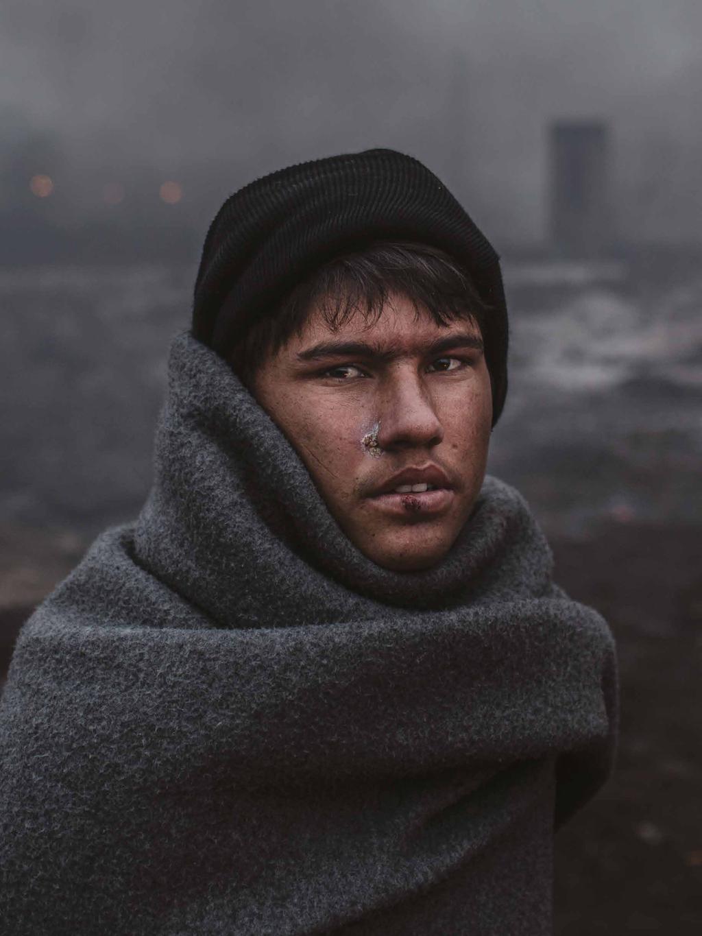 Asylum-seekers Serbia. Refugees trapped in transit. Hazrat, a 16-year old Afghan refugee, struggles to keep warm in freezing conditions in Belgrade.