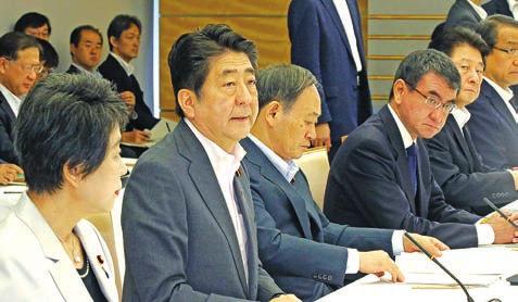 WORLD 13 Abe says Japan wants to accept more foreign workers from April Prime Minister Shinzo Abe (2nd from L) speaks during a ministerial meeting in Tokyo on 24 July, 2018, about a plan to accept