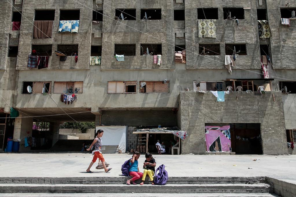 Fulvio Zanettini / ADH Syrian refugees in neighbouring countries live in a variety of accommodation types, often in urban areas, such as in this apartment block in Lebanon.