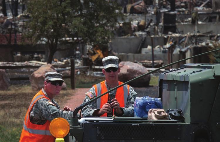 Adrees Latif/Reuters These members of the Colorado National Guard help in the aftermath of a major fire.