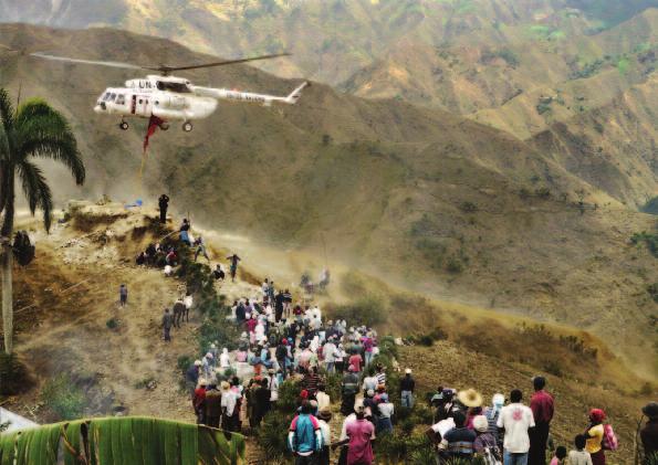 A UNHAS helicopter brings rice to the mountain district of Moussambe, Haiti.