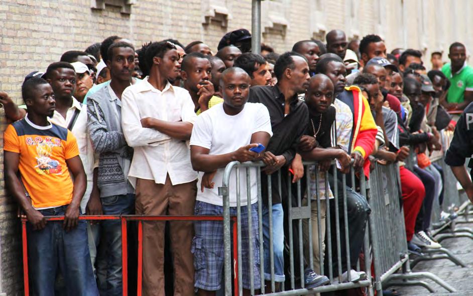 The Ten- Year Emergency Refugees line up for a meal outside of Centro Austelli, a soup kitchen in Rome. The reality of the European refugee problem is evident on the streets of Rome.