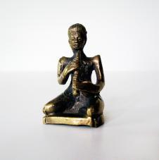 Chhing [cymbals] A chhing is a small pair of cymbals, like the ones which this figurine is playing, and