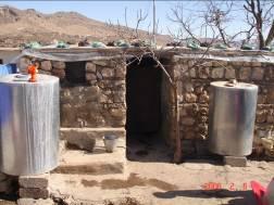 Two-room IDP shelter with makeshift roof in Sumel District, home to a family of four.