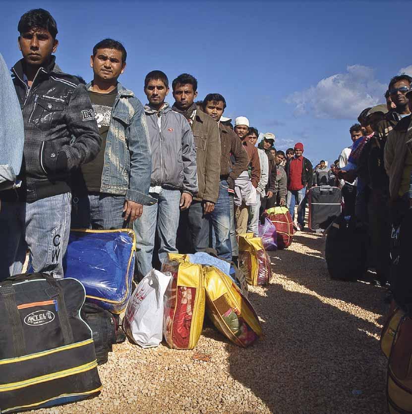 Refugees and migrant workers in Benghazi port, Libya waiting in line for their passport to be checked by an international organization before boarding a