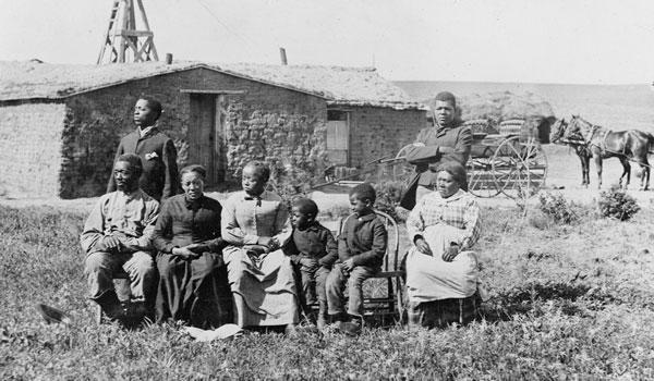 Norwegian settlers in 1898 North Dakota in front of their homestead, a sod hut.