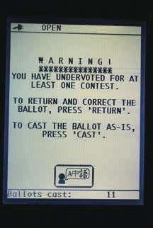 9. The voter will put their ballot in the scanner, and the voting machine will read their ballot.