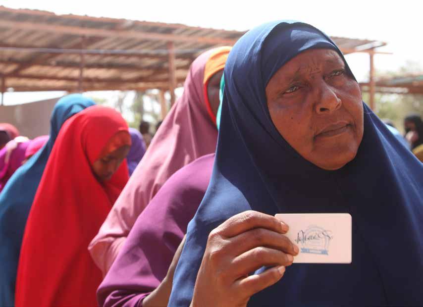 ABOVE: A delegate displays her identification card during the electoral process to choose members of the Lower House of the Federal Parliament in Kismaayo, Somalia. November 2016.