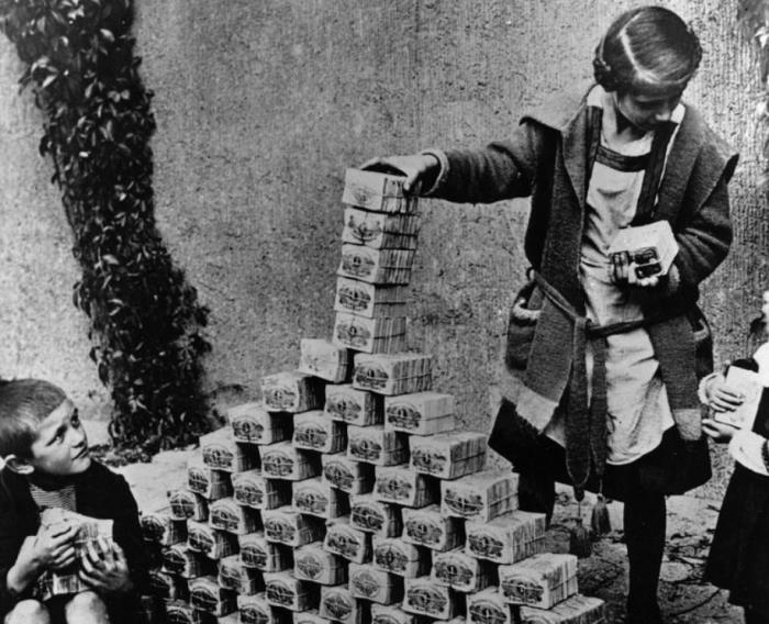 This picture shows the despair of the economy of Europe after the effects of WWI. These kids are using stacks of money as building blocks to make a tower.