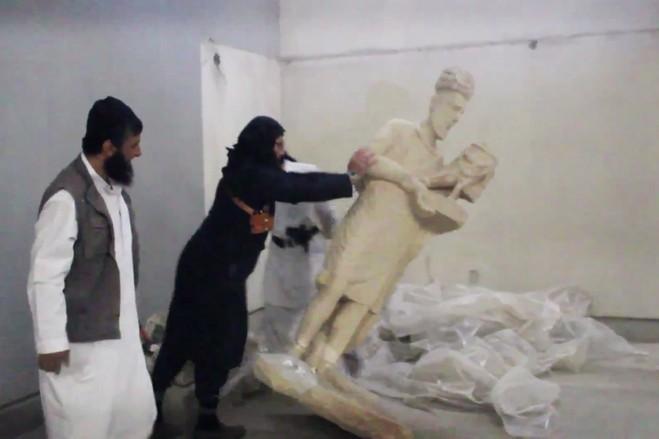 which have survived for over 1,300 years and even lived through the Mongol invasion. A photograph of ISIL militants destroying a museum in Mosul, Iraq.