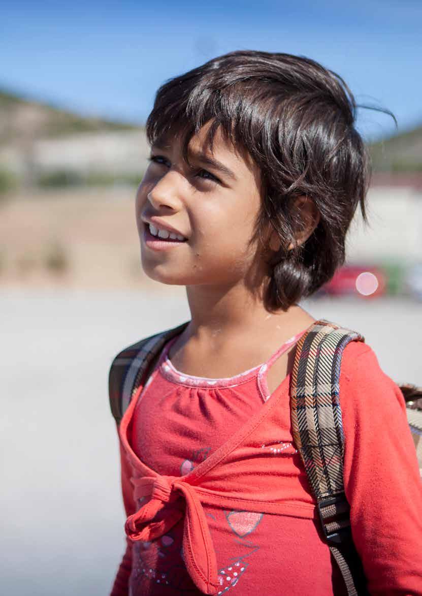 7 year old Khadija from Syria returns home after attending class at the open accommodation site of Volos, Greece.