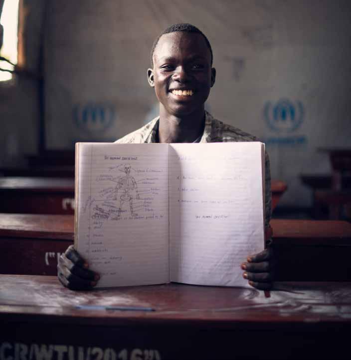 I WANT TO BE A SCIENTIST Daniel is a budding scientist and was top of his class in South Sudan. He is sitting at the back of his classroom quietly reading his book.
