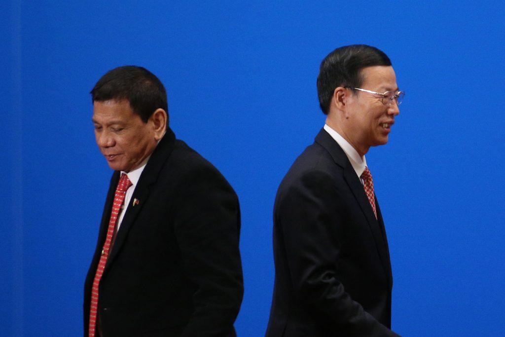 China s Vice-Premier Zhang Gaoli, right, walks past Philippine President Rodrigo Duterte in a file photo from the Philippines- China Trade and Investment Forum at the Great Hall of the People in