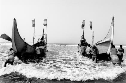 On the coast of Bangladesh, a group of refugees from northern Rakhine State in Myanmar push their fishing boats out to sea.