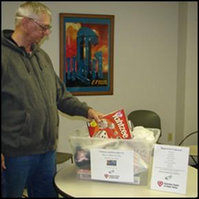 Continued-BLACK HAWK LABOR COUNCIL Union Members Donate to Country View In the picture above Roger Dettmer, a Machinist Member at Universal Industries, adds his donation to a collection for the