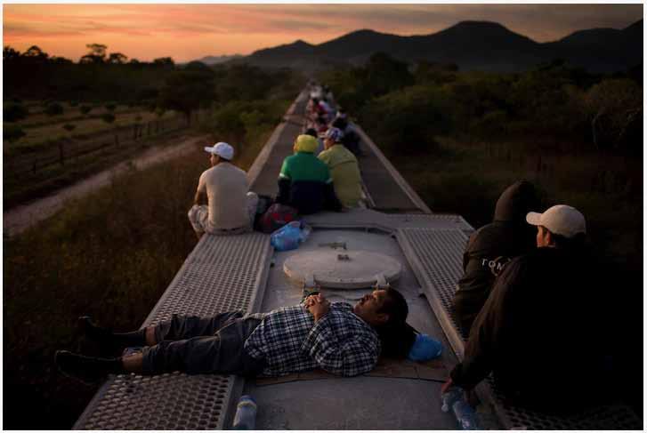 David Rochkind Central American migrants ride atop a freight train carrying cement through Chiapas and in to Oaxaca as they head north in an attempt to