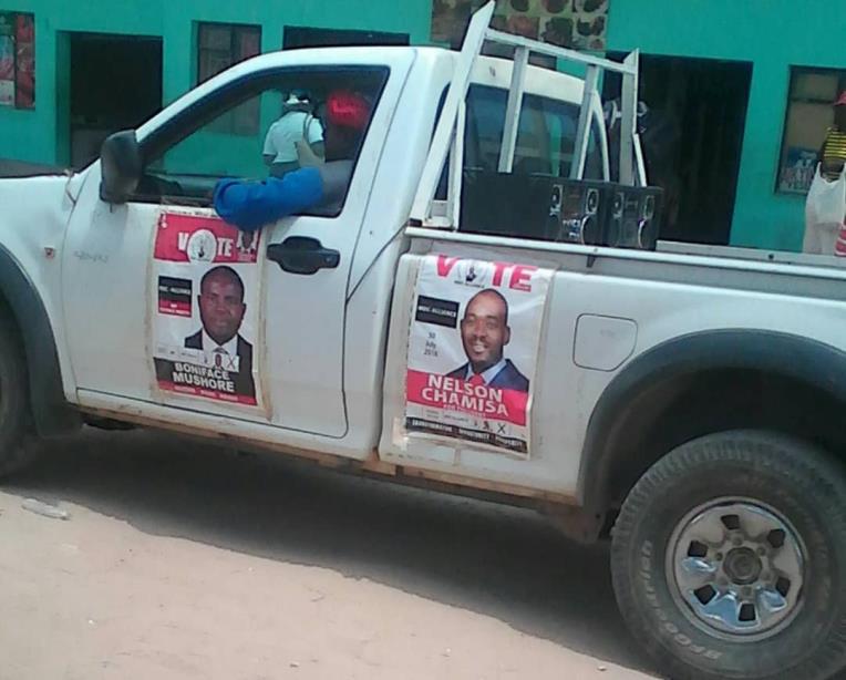 around Chitekwe and Kanyongo townships in a car playing loud music and pasting campaign posters on trees.