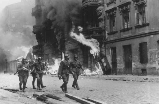 German soldiers burn residential buildings to the ground, one by one, during the Warsaw