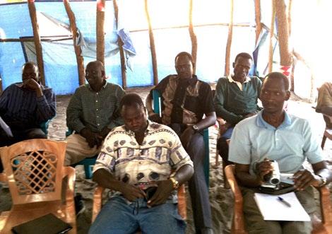 16 AG members and SSI staff in Ayod County listen to a briefing by Jonglei State Minister for Law Enforcement and Security H.E. Gabriel Duop Lam.