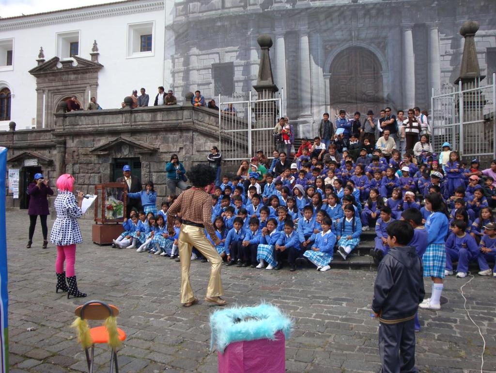 Students watching street theatre performance in