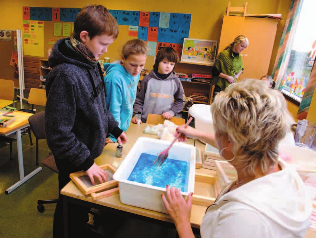 making paper Nine-year-olds Tomas, left, and Mindaugas make blue-tinted paper from recycled waste. Teacher Cecilie Barra uses recyling in her introductory classes at Sund school outside Bergen.