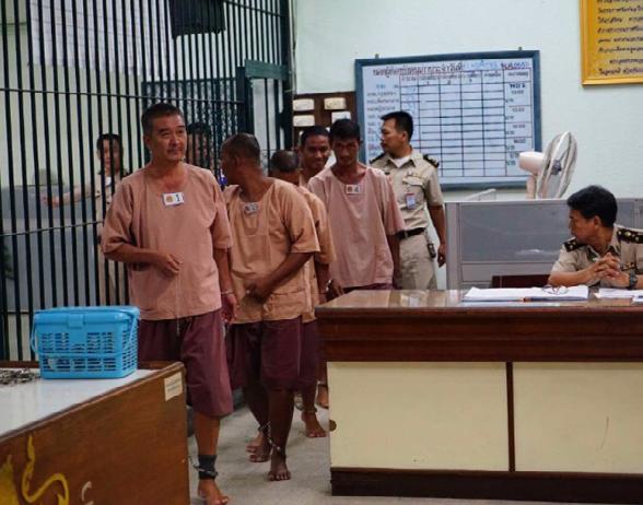 Defendants accused of trafficking Rohingya Muslims from Myanmar and Bangladeshi nationals enter a Bangkok courtroom prior to their conviction.