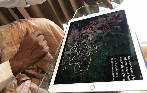 Rohingya survivor uses Human Rights Watch satellite imagery to explain to Fortify Rights how Myanmar Army soldiers burned down Wa Peik village, Maungdaw Township, Myanmar.