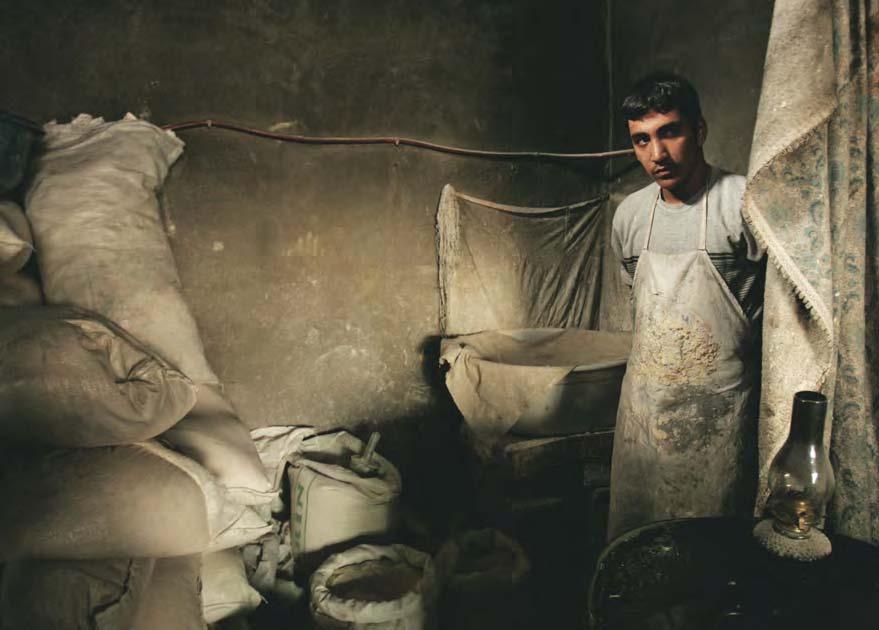 An Iraqi who fled sectarian killings and kidnappings supports his family by working as a baker in another part of Iraq. How are the two groups treated?