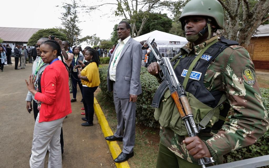 Kenya police officers stand announcement Credit: EPA guard ahead of Friday s A police officer stands guard at the national tallying centre as Kenyans await the announcement on Friday Credit: EPA We