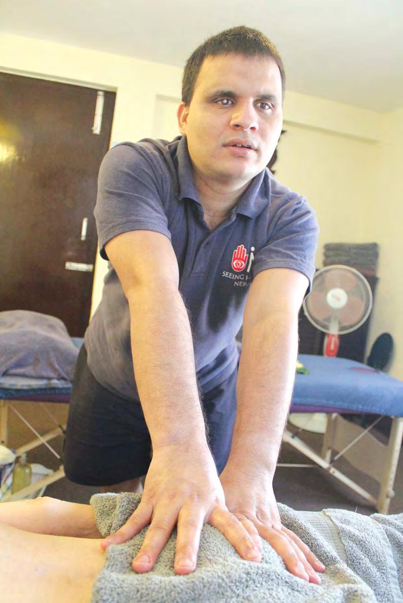4 BUSINESS SENSITIVE TOUCH : Chiranjivi Poudel of Seeing Hands Kathmandu attends to a client.