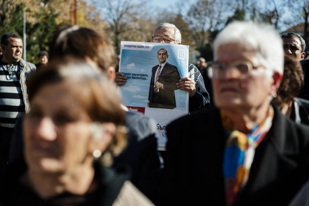 A supporter of the Bulgarian Socialist Party holds a picture of former air force commander Rumen Radev during a pre-election rally in the town of Byala Slatina, on Nov. 2, 2016.