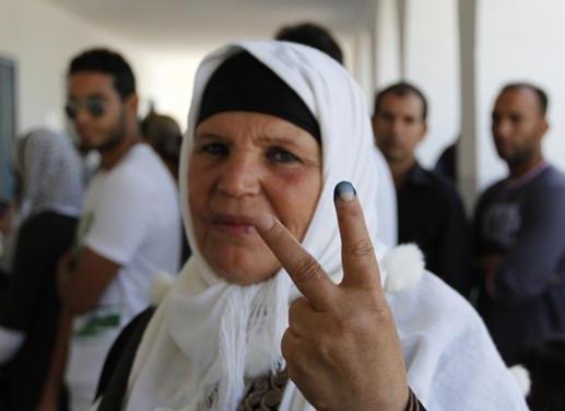 Manoubia Bouazizi, mother of Mohamed Bouazizi, the Tunisian man who set himself on fire in an act of protest which inspired the Arab Spring, gestures after casting her ballot at a